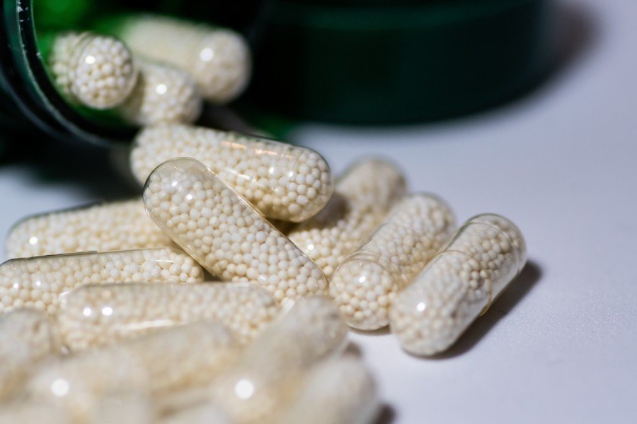 Close-up of capsules spilling from a bottle for piles care and wellness treatment